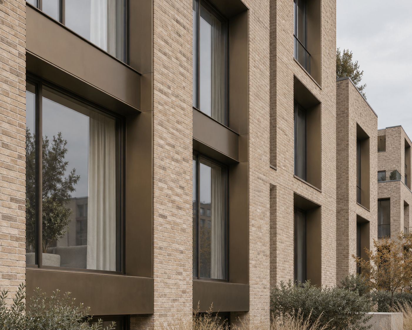 Brick and bronze-clad facade of a new residential building